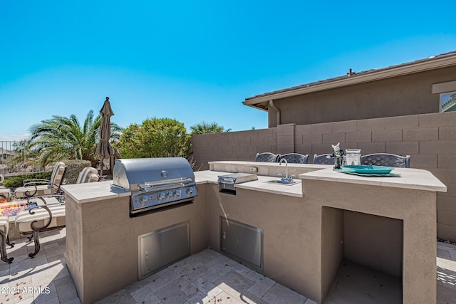 view of patio featuring exterior kitchen and grilling area