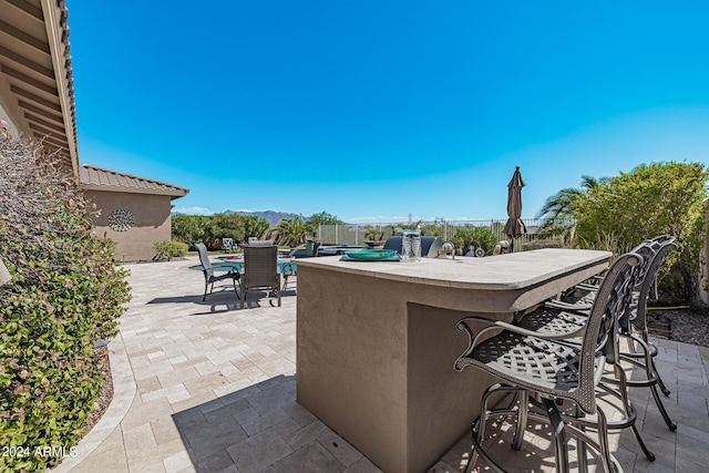 view of patio featuring an outdoor bar