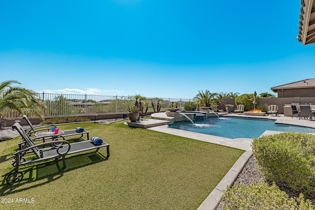 view of pool featuring pool water feature, a patio, an in ground hot tub, and a lawn