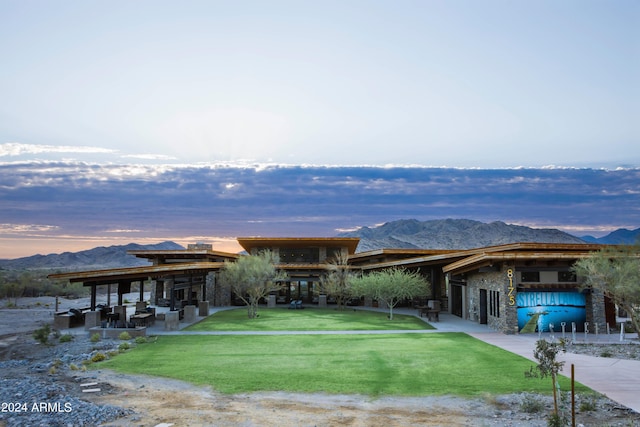 exterior space with a mountain view and a yard