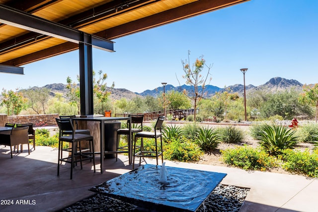 view of patio / terrace featuring a mountain view and exterior bar