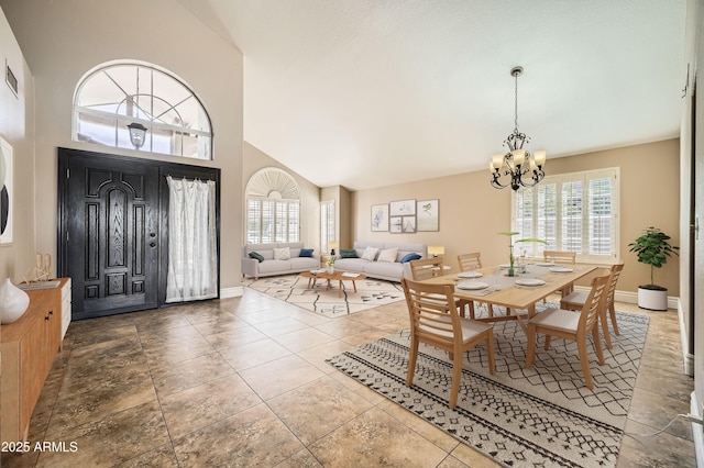 tiled dining room with an inviting chandelier, high vaulted ceiling, and a wealth of natural light