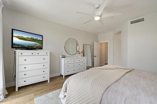 19203 N 39th Way, Phoenix, AZ 85050 - bedroom with light wood-type flooring, baseboards, a ceiling fan, visible vents, and arched walkways
