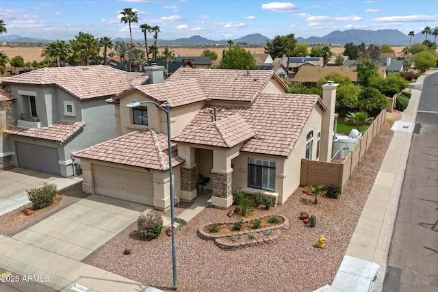 19203 N 39th Way, Phoenix, AZ 85050 - view of front of home featuring a mountain view, a chimney, fence, stucco siding, and driveway