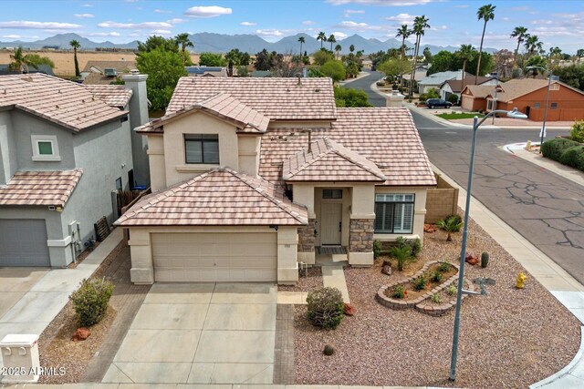 19203 N 39th Way, Phoenix, AZ 85050 - view of front facade featuring a residential view, stucco siding, a mountain view, driveway, and an attached garage