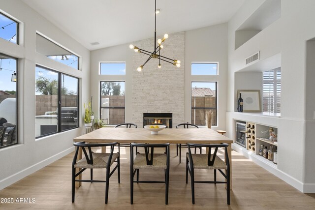 19203 N 39th Way, Phoenix, AZ 85050 - dining room with a notable chandelier, visible vents, light wood-type flooring, and baseboards