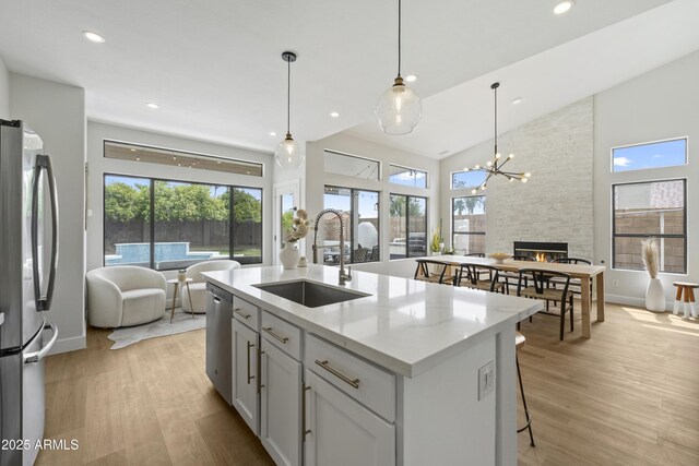 19203 N 39th Way, Phoenix, AZ 85050 - kitchen featuring a sink, open floor plan, light wood finished floors, and stainless steel appliances