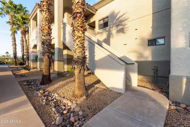 view of property exterior featuring a tiled roof and stucco siding