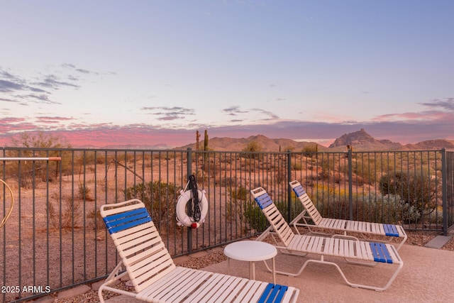 view of patio featuring fence and a mountain view