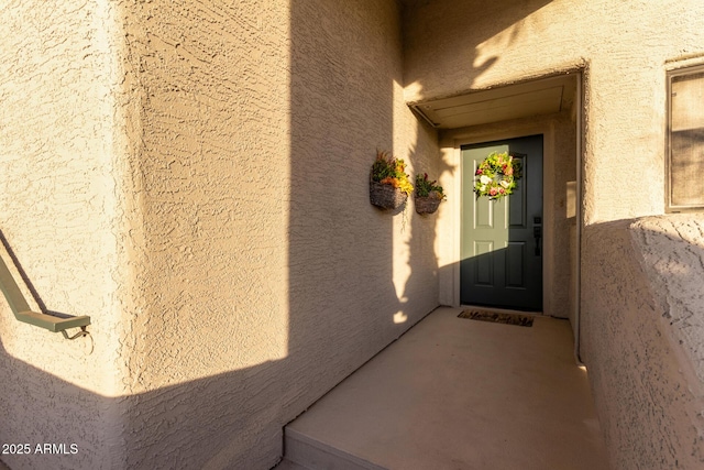 property entrance featuring stucco siding