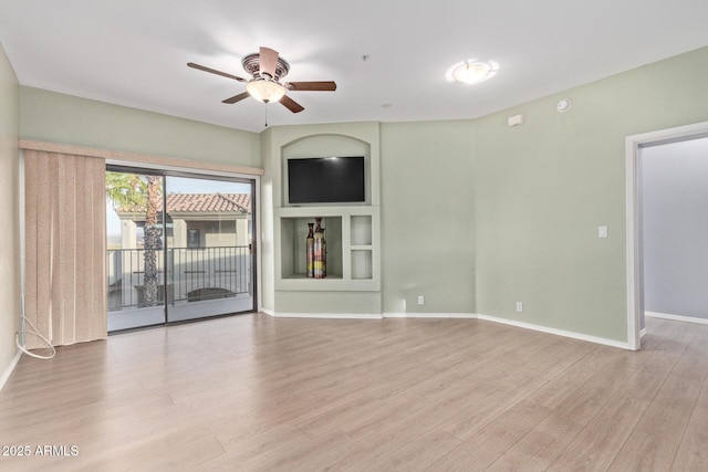 unfurnished living room with a ceiling fan, light wood-type flooring, and baseboards