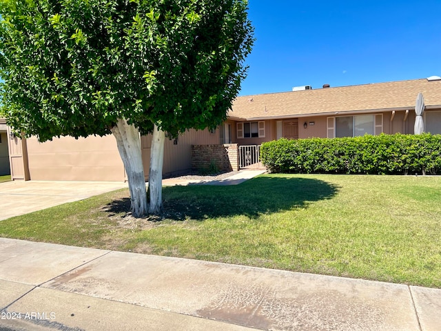 view of front facade with a front lawn and a garage