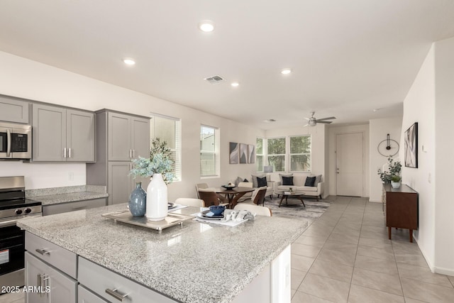 1879 W 23rd Ave, Apache Junction, AZ 85120 - kitchen featuring stainless steel appliances, gray cabinets, a center island, light tile patterned floors, and recessed lighting