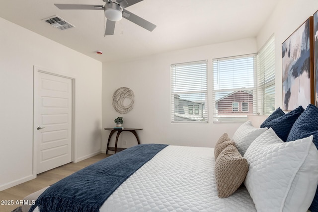 1879 W 23rd Ave, Apache Junction, AZ 85120 - bedroom with light wood-type flooring, baseboards, and ceiling fan