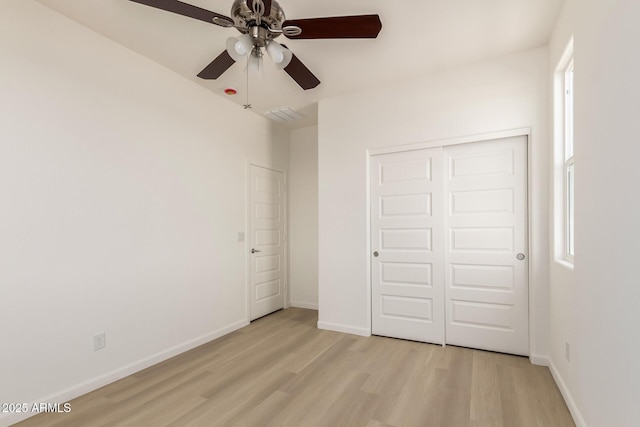 1879 W 23rd Ave, Apache Junction, AZ 85120 - unfurnished bedroom featuring light wood-style floors, a closet, baseboards, and ceiling fan