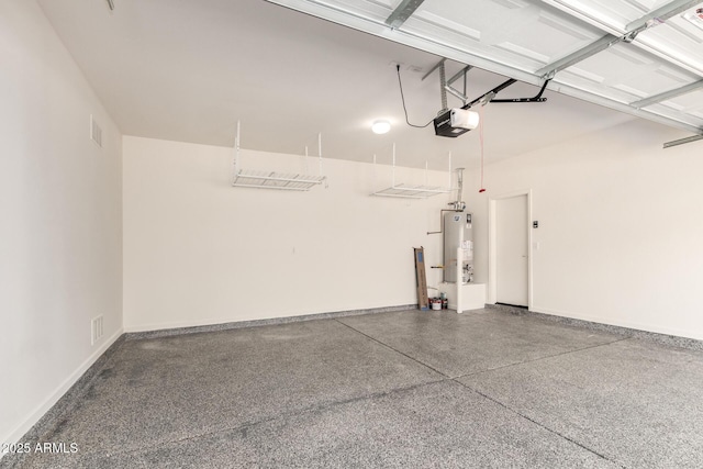1879 W 23rd Ave, Apache Junction, AZ 85120 - garage featuring a garage door opener, gas water heater, and baseboards