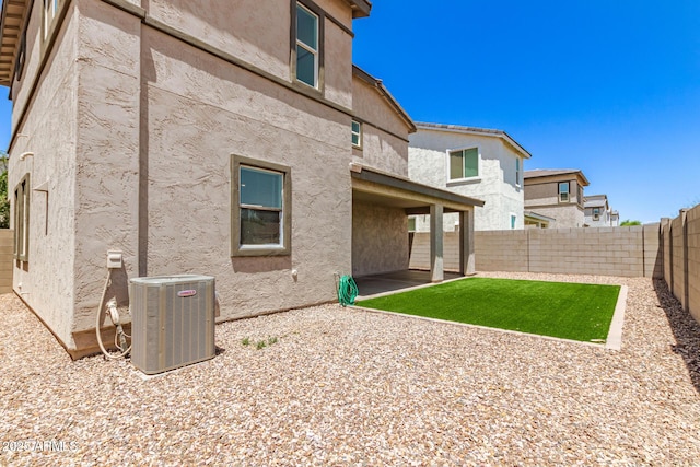 1879 W 23rd Ave, Apache Junction, AZ 85120 - rear view of house with central AC unit, a patio area, and stucco siding
