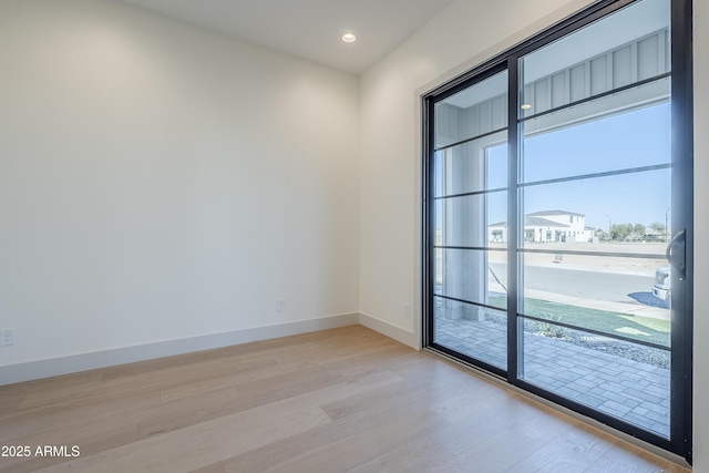 spare room featuring light wood-type flooring