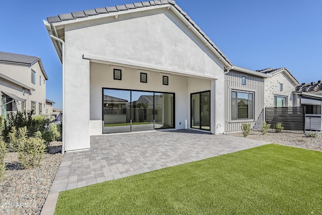 back of house featuring a yard and a patio