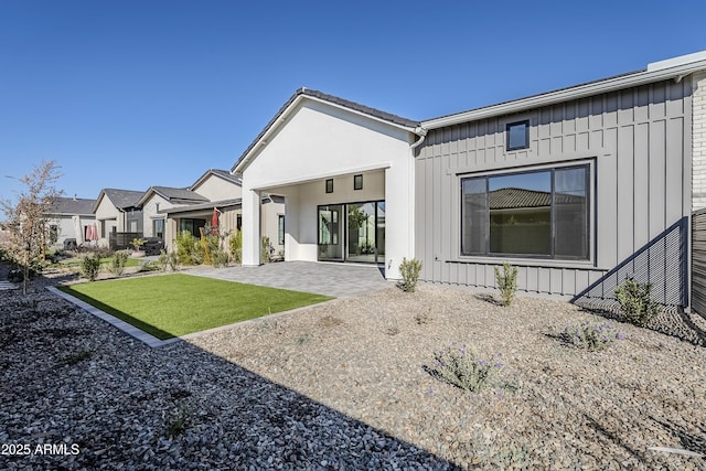 back of house featuring a yard and a patio area