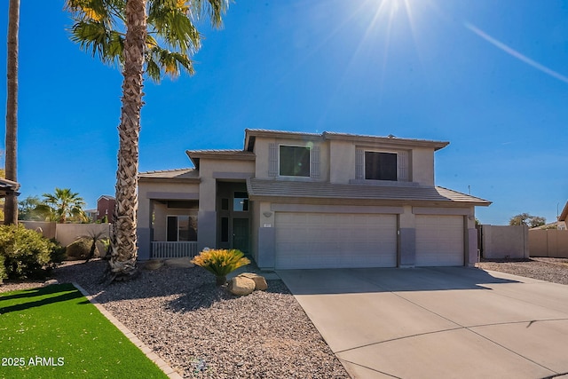 view of front of house featuring a garage, concrete driveway, fence, and a tiled roof