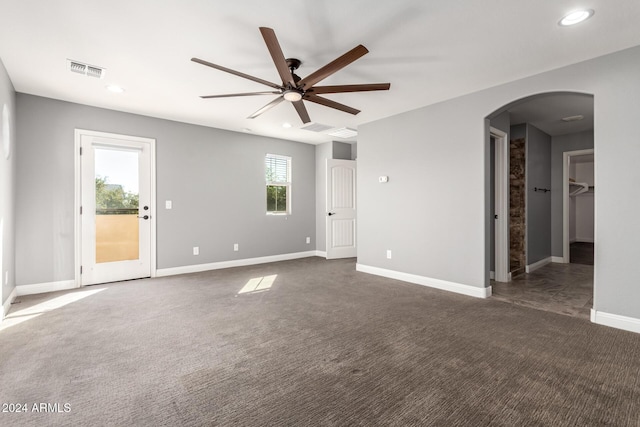 unfurnished room featuring dark colored carpet and ceiling fan