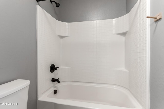 bathroom featuring shower / bathing tub combination and toilet