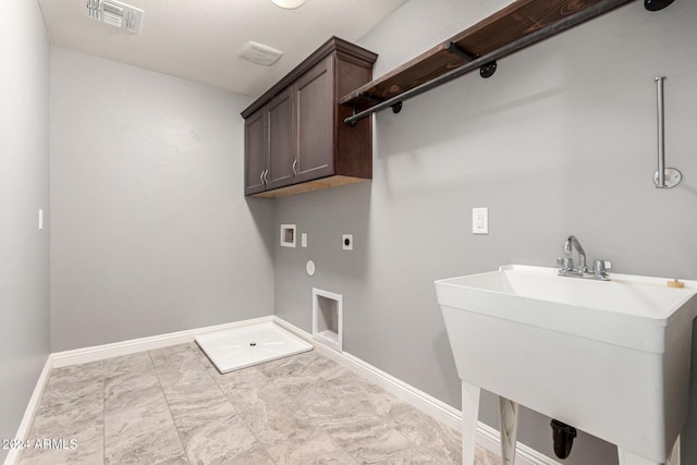 washroom featuring hookup for an electric dryer, hookup for a washing machine, cabinets, and sink