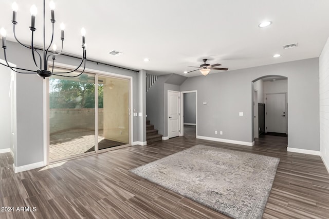 unfurnished living room featuring dark hardwood / wood-style flooring and ceiling fan with notable chandelier