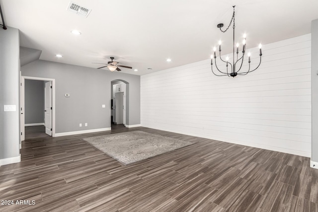 empty room featuring dark hardwood / wood-style floors and ceiling fan with notable chandelier