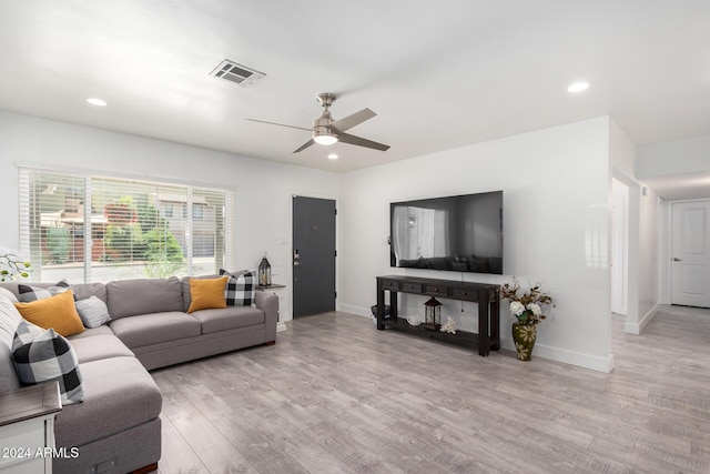 living room featuring light hardwood / wood-style flooring and ceiling fan