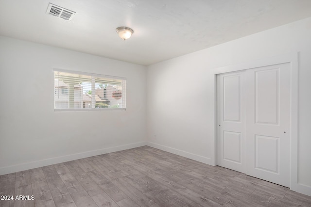 empty room with light hardwood / wood-style flooring