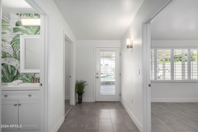 doorway with lofted ceiling and sink