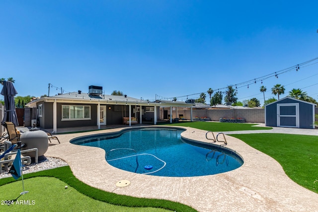 view of swimming pool with a yard, a patio, central AC unit, and a storage shed