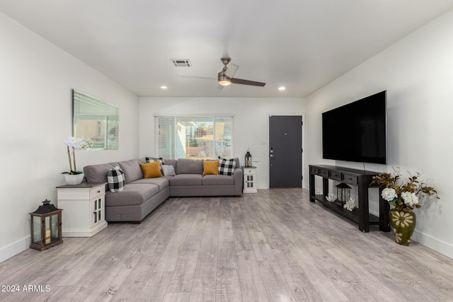 living room with light hardwood / wood-style flooring and ceiling fan