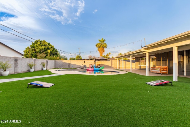 view of yard with a fenced in pool and a patio