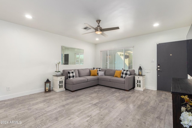 living room featuring ceiling fan and light wood-type flooring