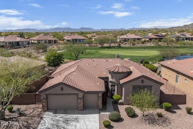 birds eye view of property featuring a mountain view, view of golf course, and a residential view