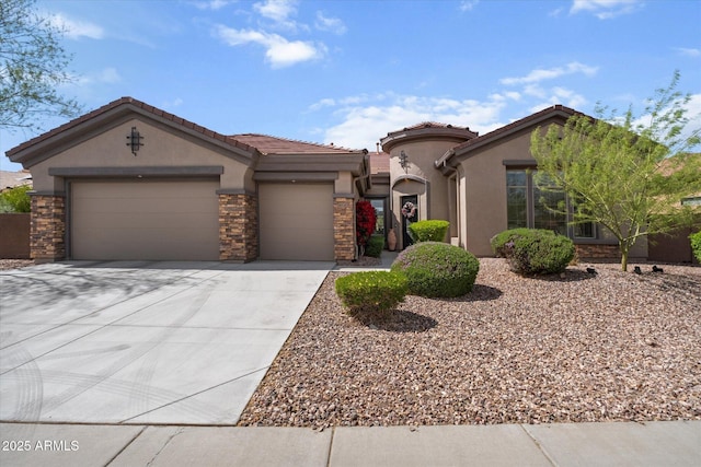 view of front of property with a tile roof, driveway, stone siding, stucco siding, and an attached garage