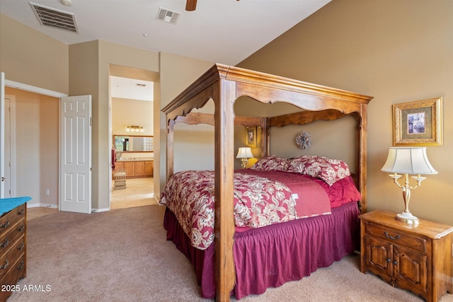 bedroom with visible vents, carpet floors, ensuite bath, and a ceiling fan