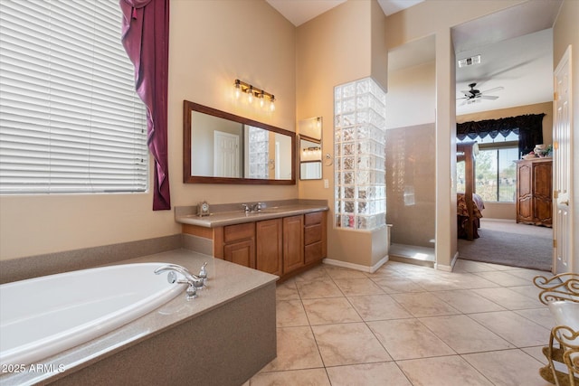 bathroom with a bath, ceiling fan, tile patterned floors, and vanity