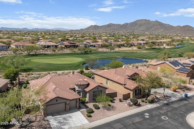 bird's eye view featuring golf course view, a water and mountain view, and a residential view