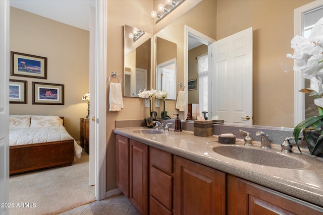 bathroom with ensuite bathroom, double vanity, tile patterned flooring, and a sink