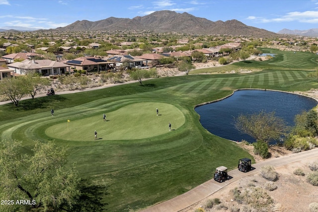 view of community with golf course view, a water and mountain view, and a residential view