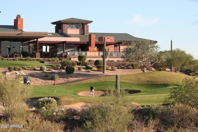 view of home's community featuring view of golf course and a lawn