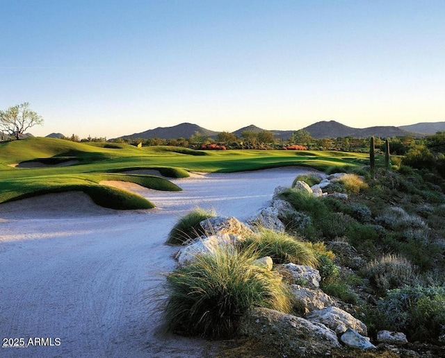 view of community featuring golf course view and a mountain view