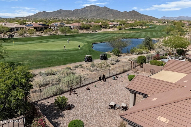 surrounding community featuring fence, golf course view, and a water and mountain view