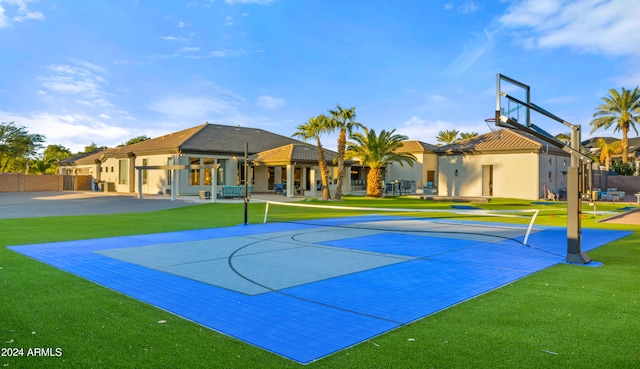 view of basketball court with community basketball court, a yard, and a residential view