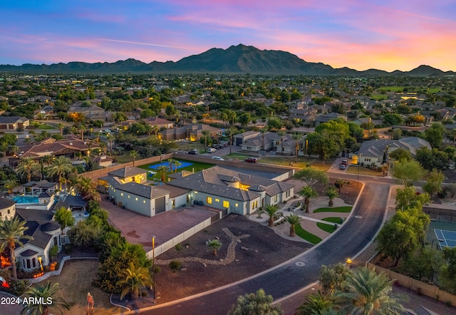 aerial view at dusk featuring a residential view and a mountain view