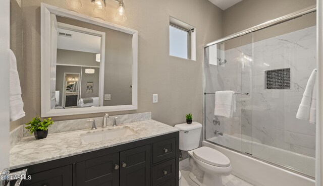 full bath with visible vents, bath / shower combo with glass door, toilet, marble finish floor, and vanity